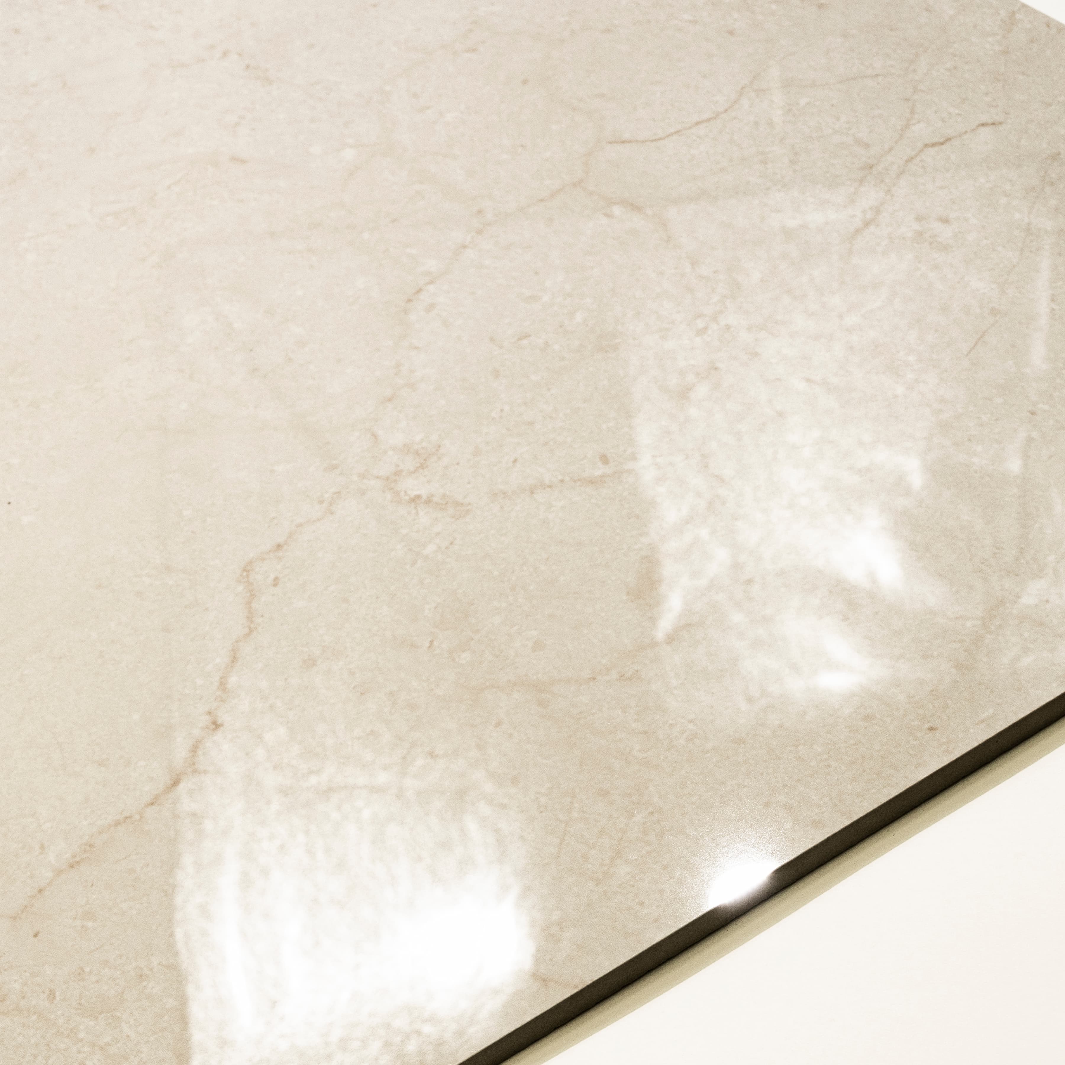 Close-up detail showing the delicate honey-caramel veining and mirror-gloss surface of Ultimate Marfil Pro porcelain tile