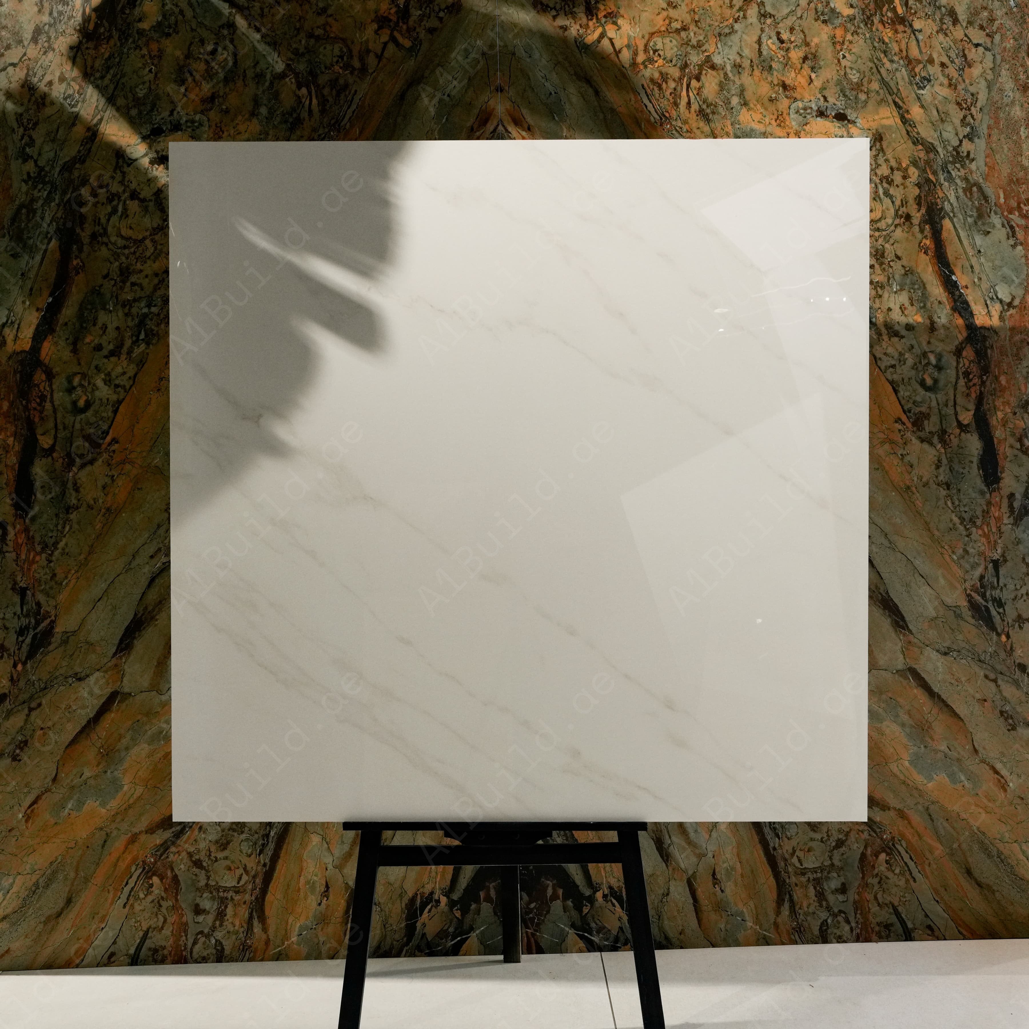 Top view of Arena Shine warm pearl-white marble-effect porcelain tile with delicate diagonal veining and glossy finish