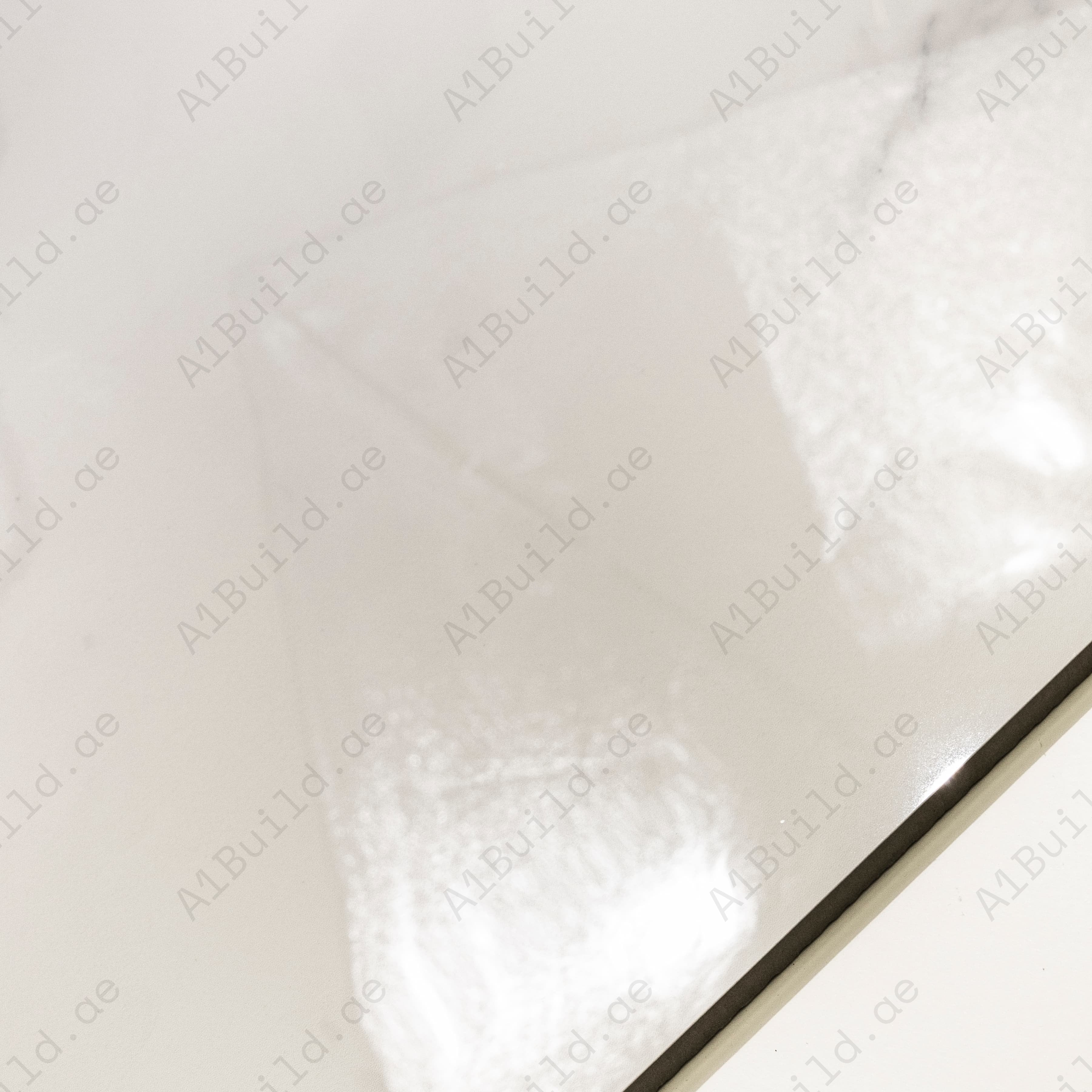 Close-up of Elite White high-gloss polished porcelain surface revealing refined subtle veining detail
