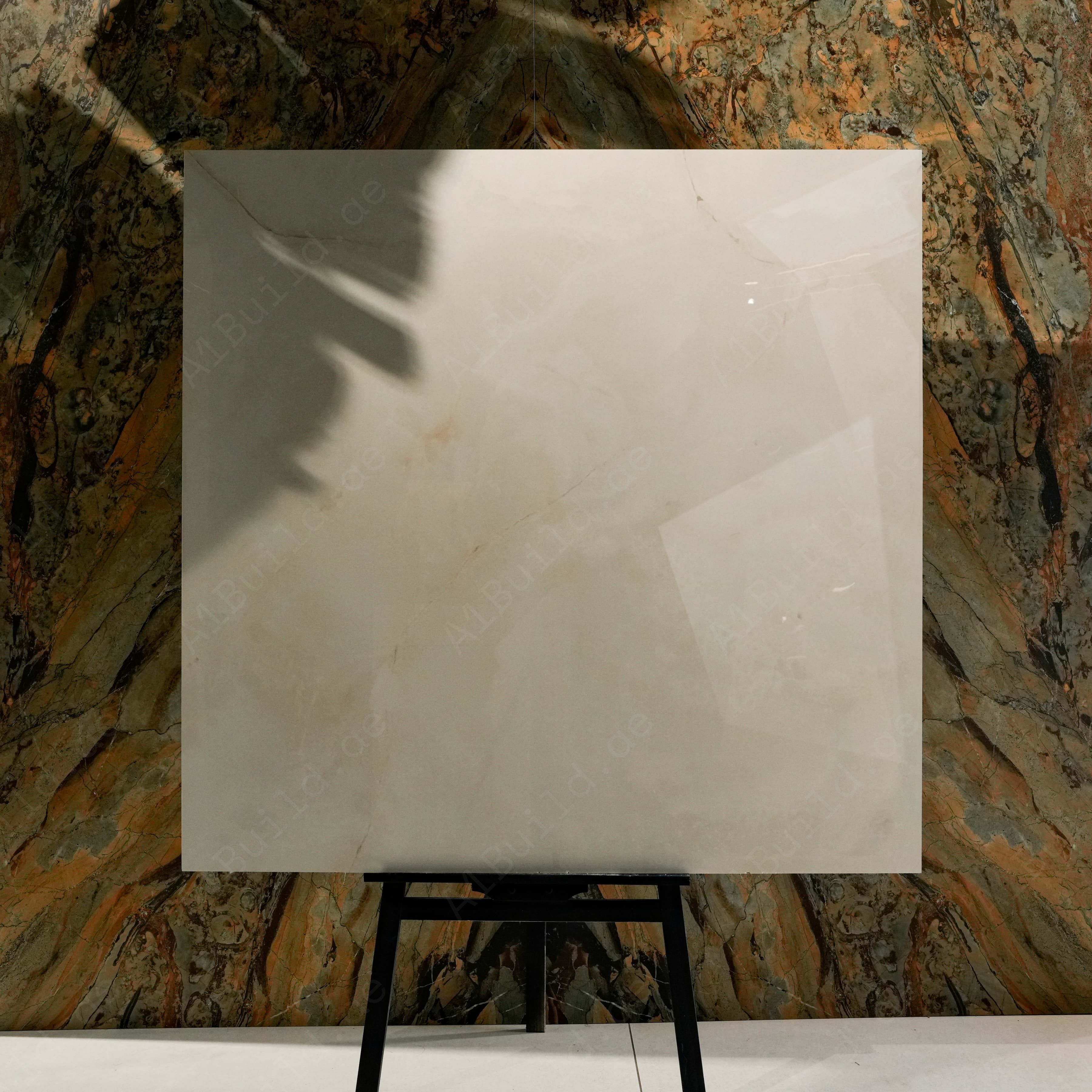 Cremasm 139 Glossy 120x120 porcelain tile displayed on easel against natural marble backdrop in UAE showroom