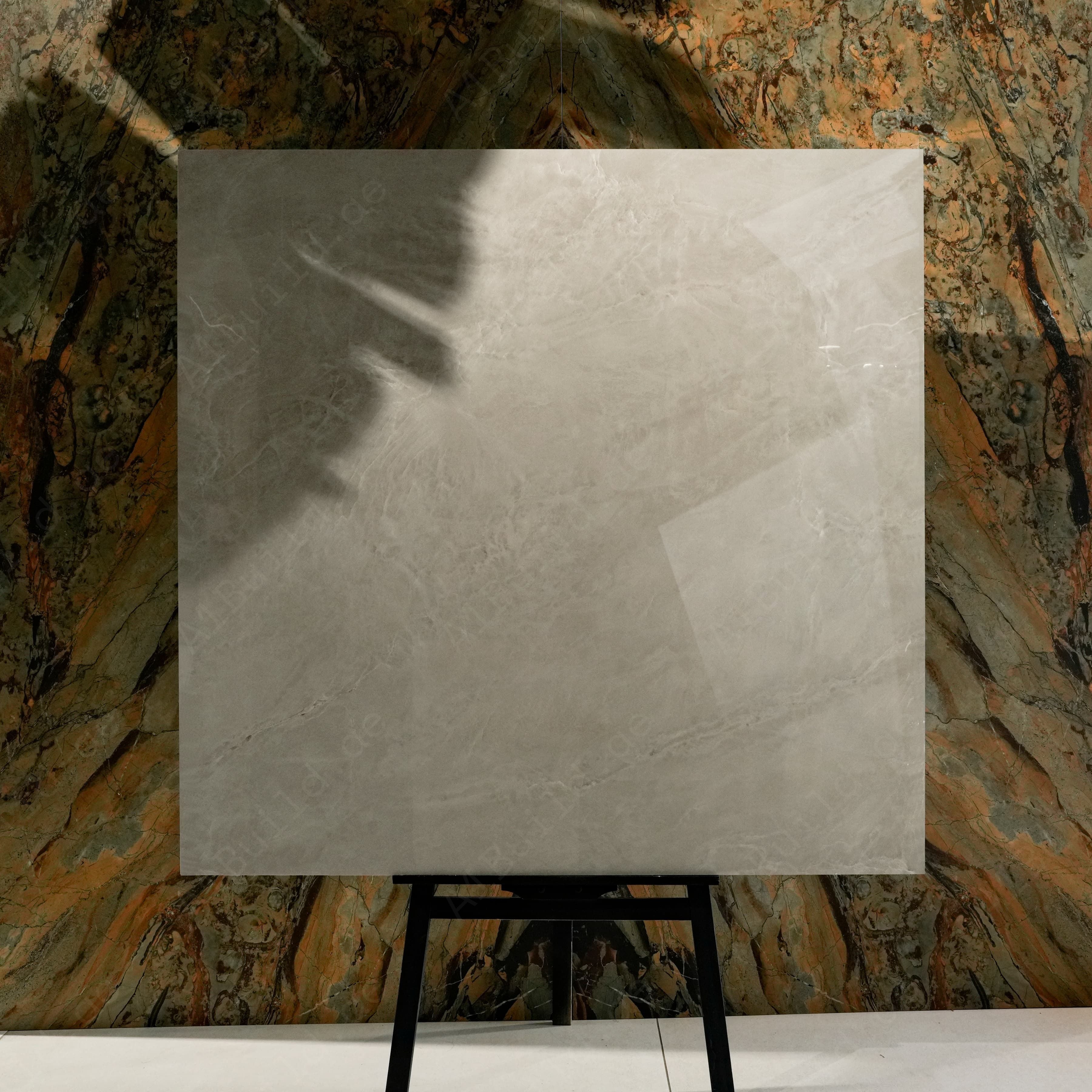 Royal Beige Glossy 120x120 porcelain tile displayed on easel against natural marble backdrop in UAE showroom