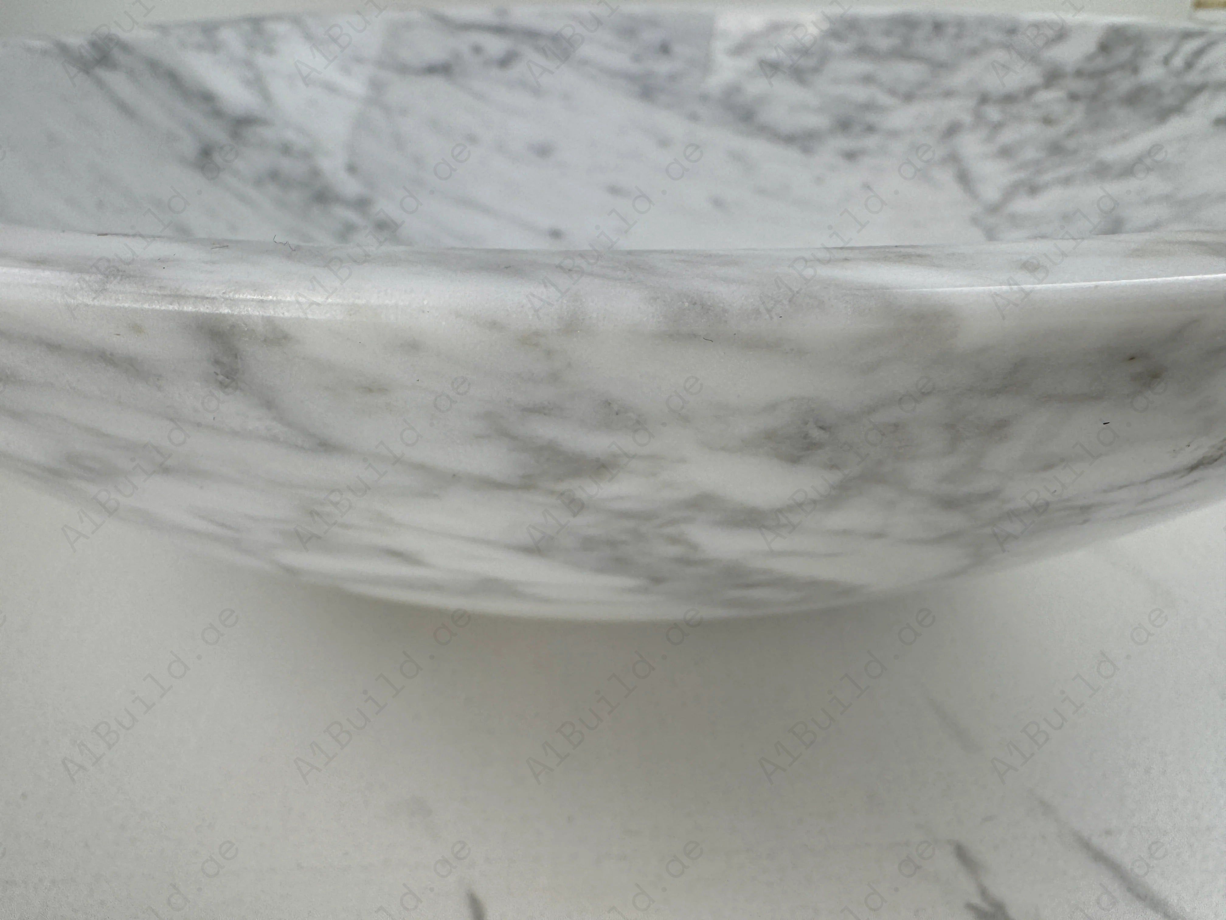 Add timeless elegance to your bathroom with the Marble Muse Carrara White Round Wash Basin, crafted from premium polished marble for lasting beauty and style.