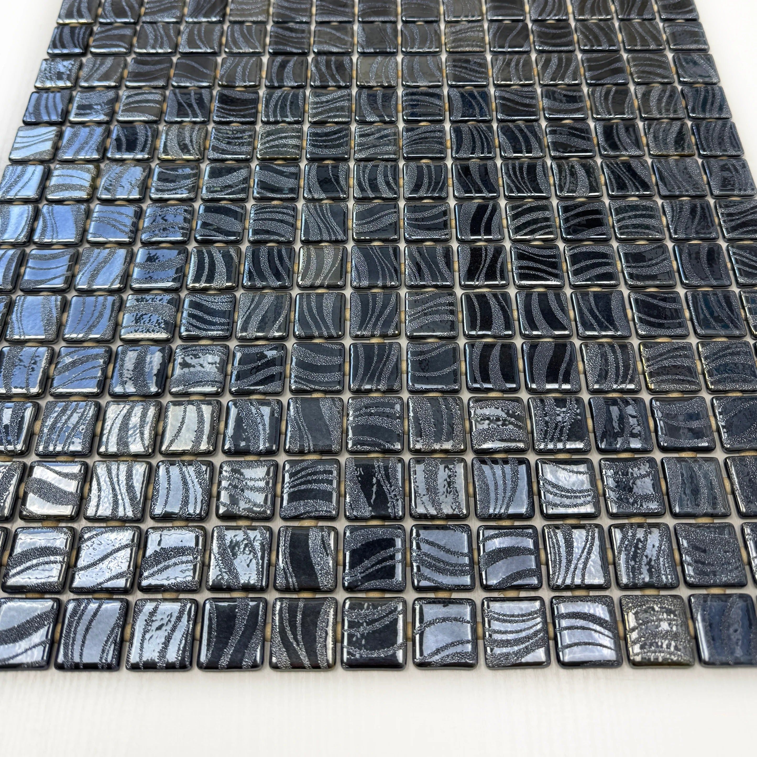 Recycled glass mosaic in iron grey & ash grey with shiny streaks and swirls. Slip-resistant, UV & corrosion-resistant—perfect for pools, spas & walls.