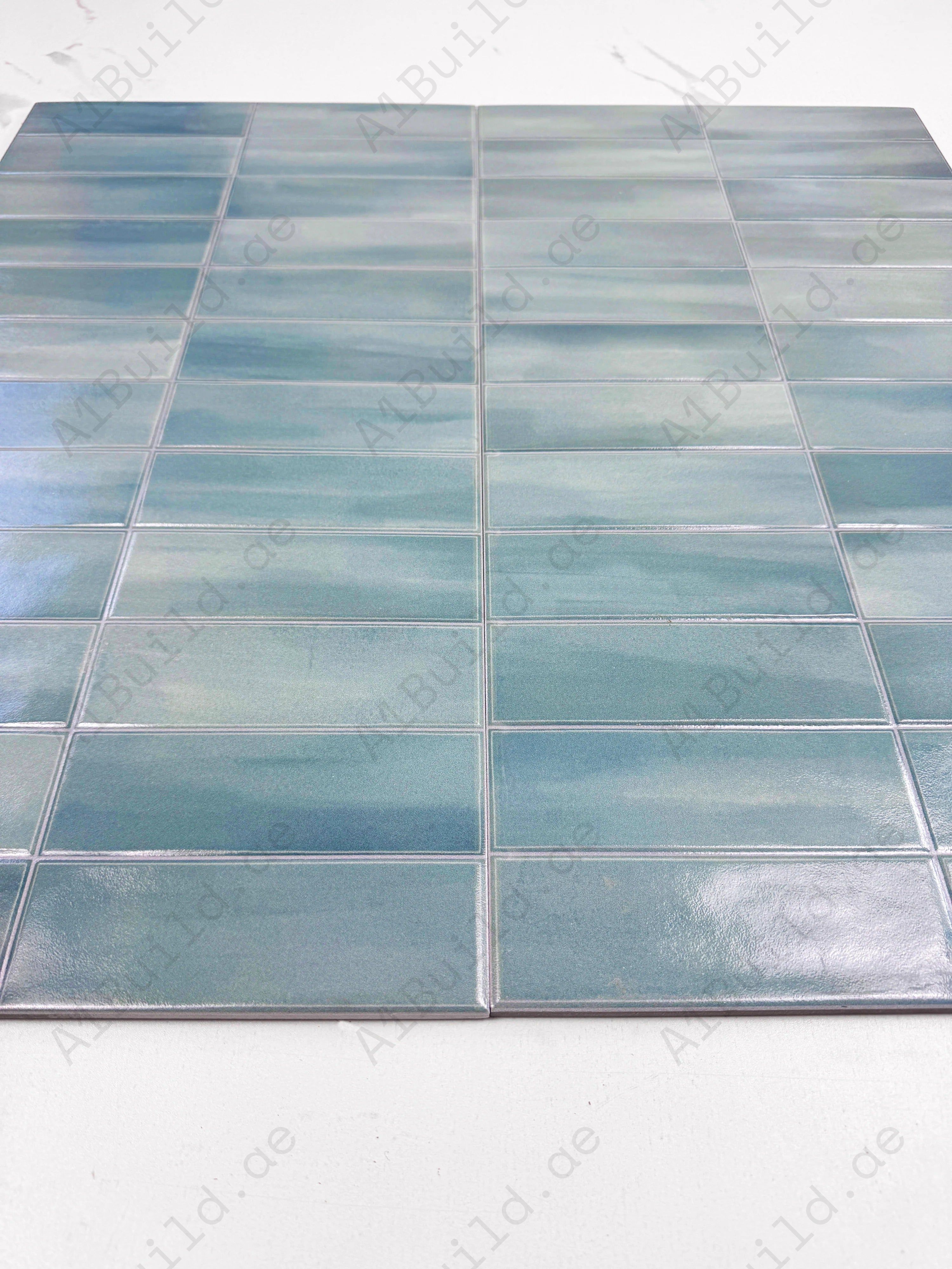 Soft Green glossy ceramic tile with elegant long-strip design. Durable, waterproof, and stain-resistant—ideal for walls, floors, kitchens & bathrooms.