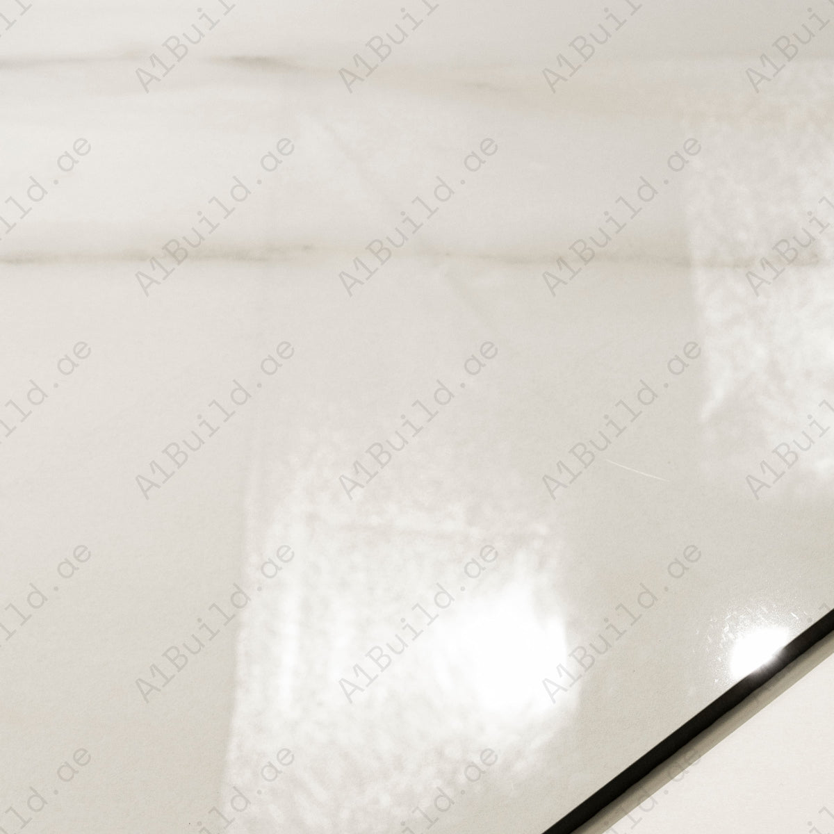 Close-up detail showing the soft veining and mirror-gloss finish of Calcutta Aurora porcelain tile