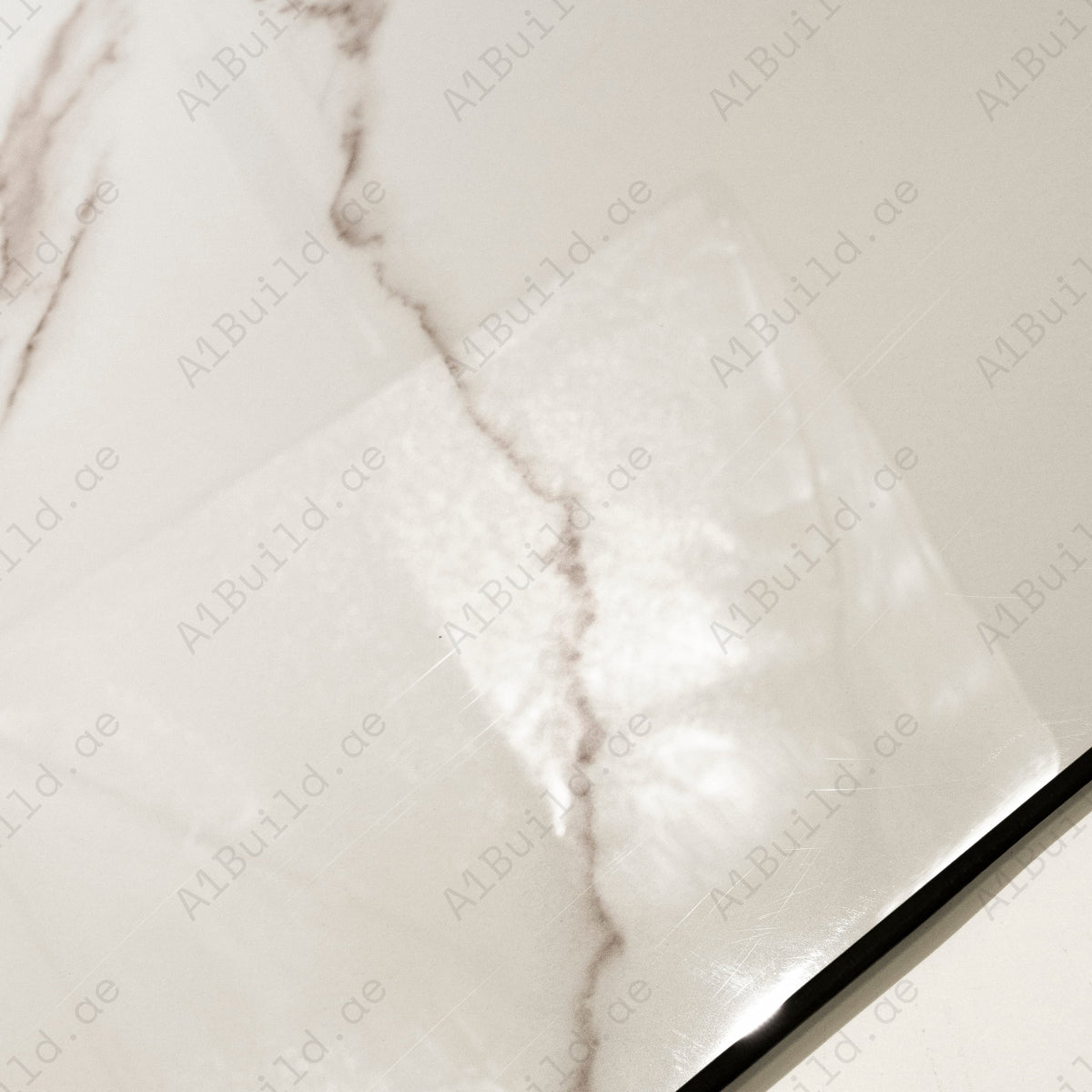 Close-up detail showing the soft rose veining and mirror-gloss finish of Grisia Pink porcelain tile