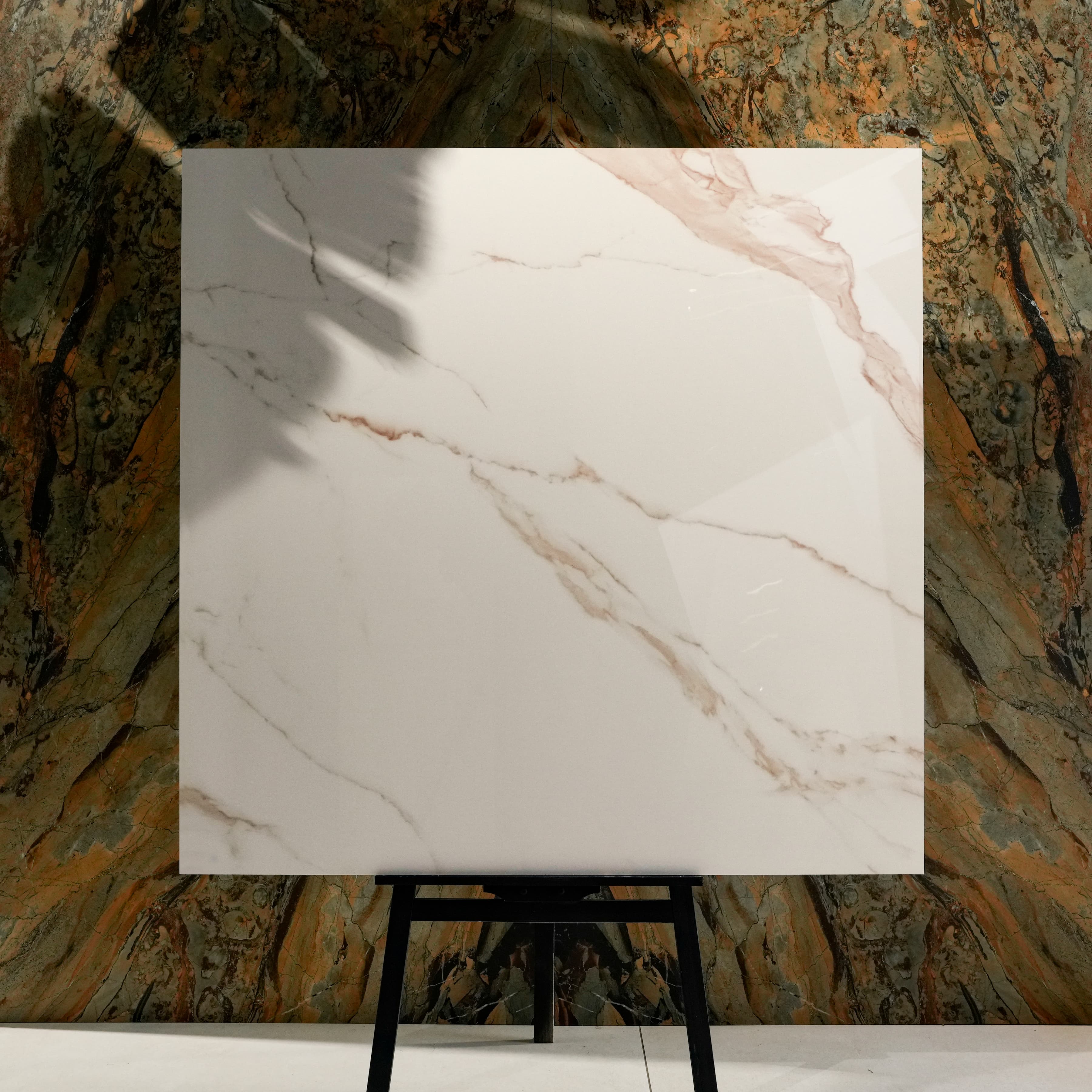 Grisia Pink Glossy 120x120 porcelain tile displayed on easel against natural marble backdrop in UAE showroom