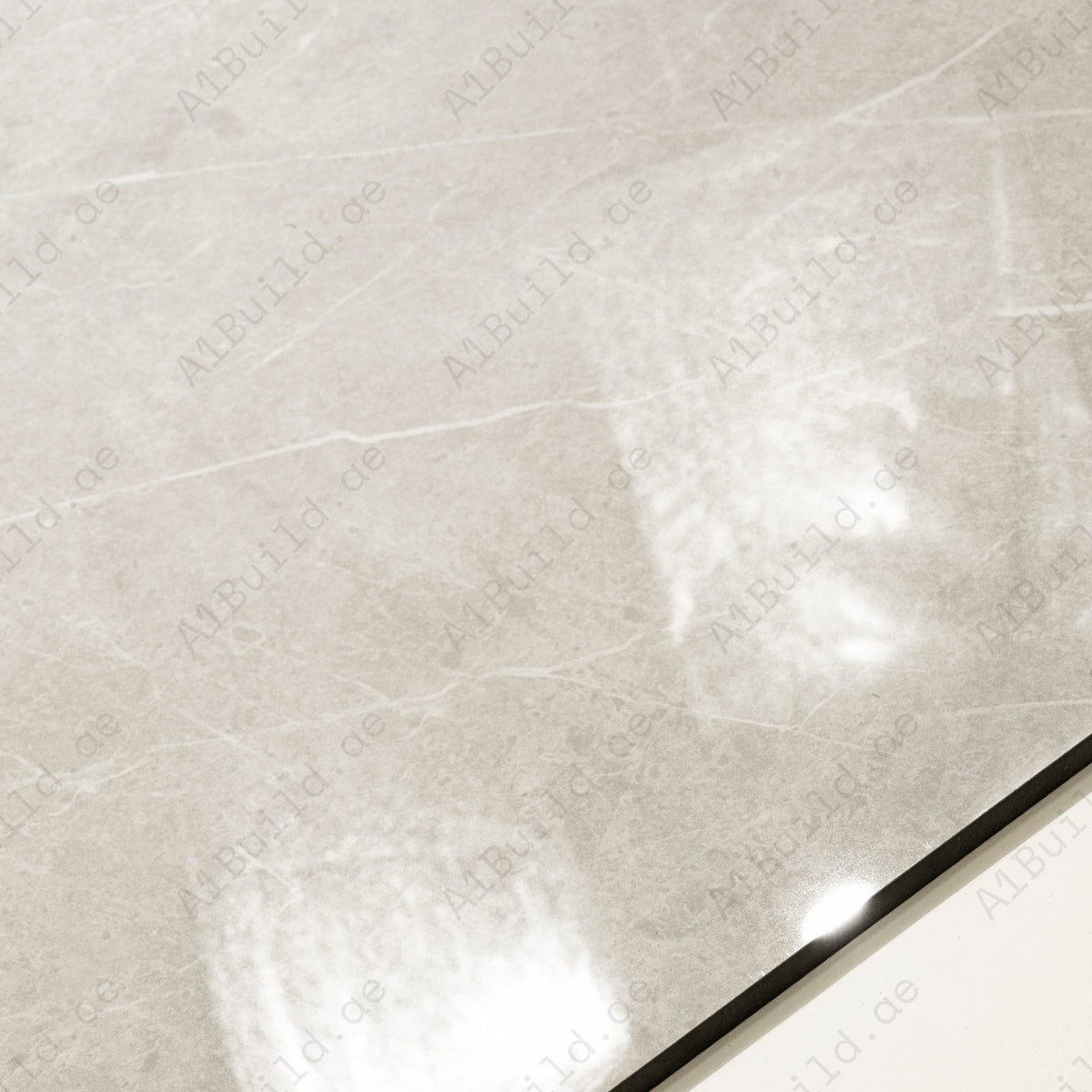 Close-up detail showing the soft veining and mirror-gloss surface of Pietra Bianco porcelain tile