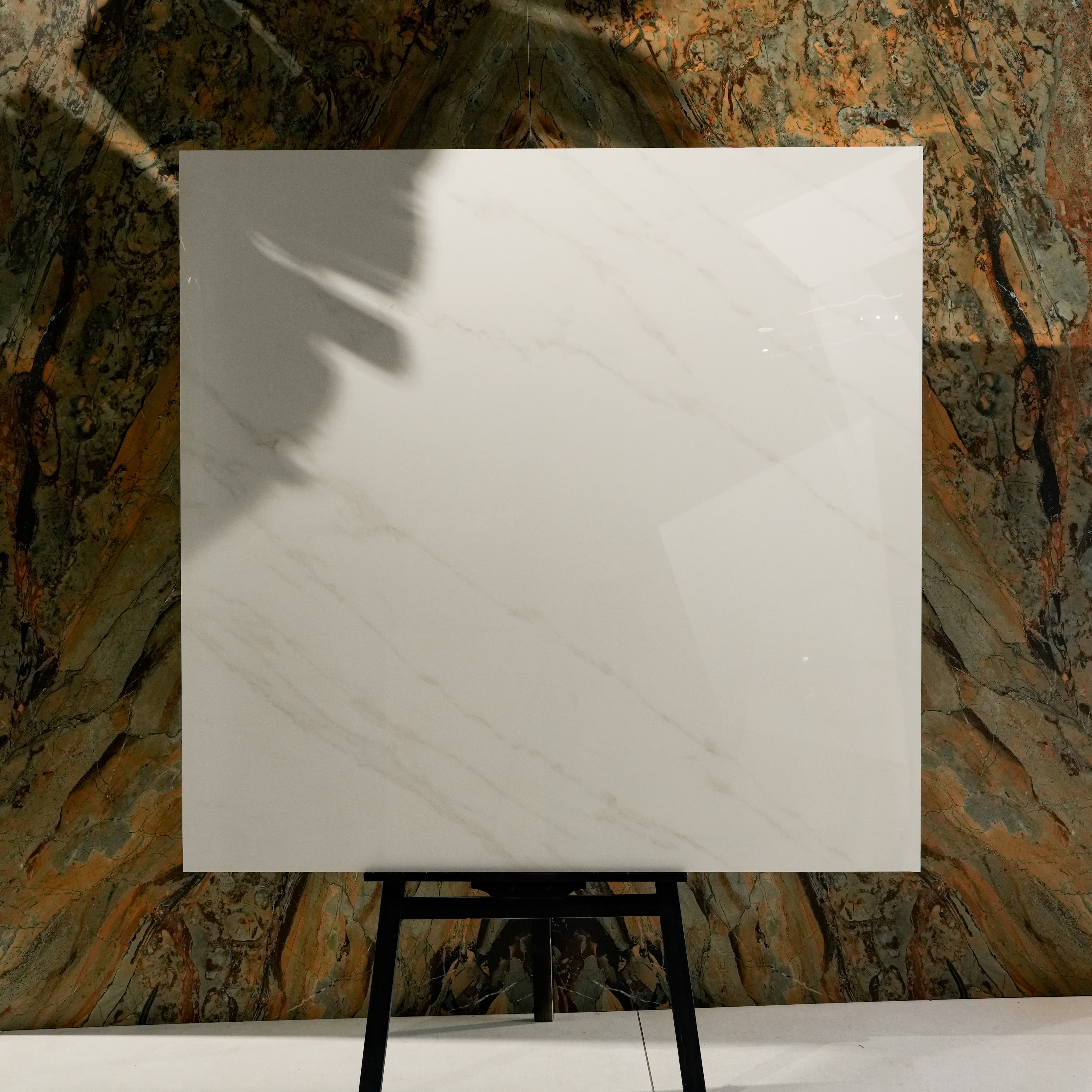 Top view of Arena Shine warm pearl-white marble-effect porcelain tile with delicate diagonal veining and glossy finish