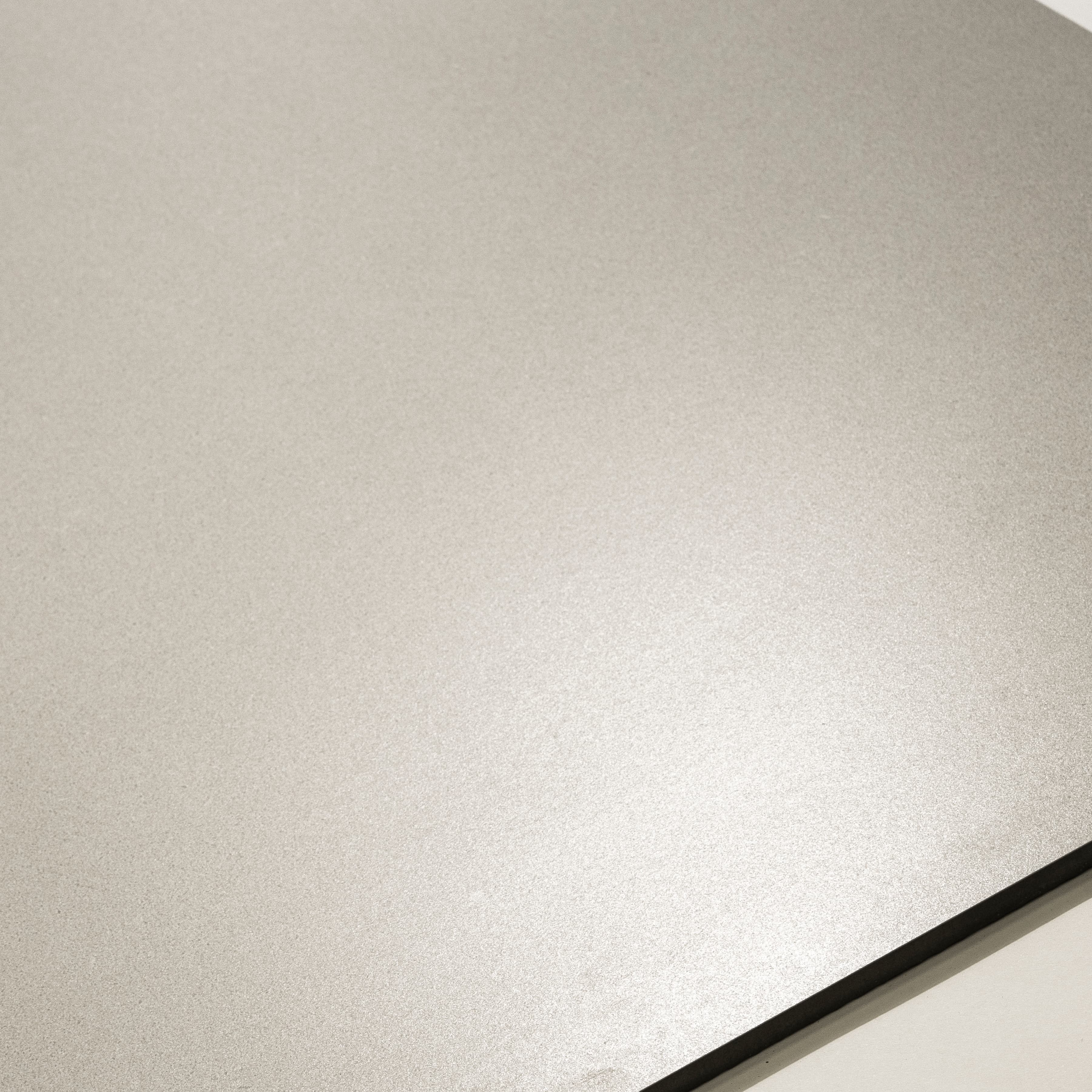 Close-up of Santorini Light matte porcelain surface showing smooth fine-grain warm white finish