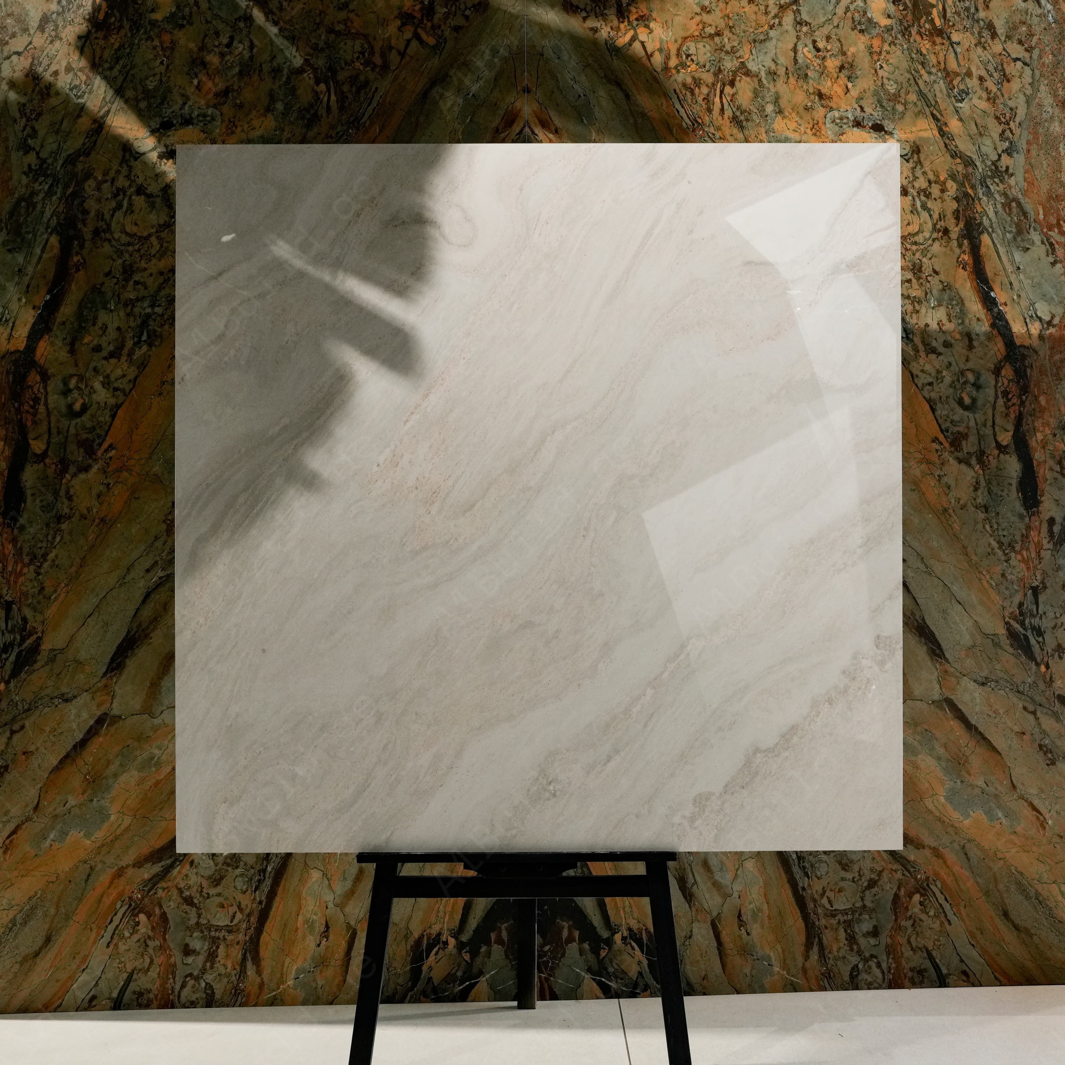 Antaliya White glossy porcelain tile 120x120 cm displayed on easel against luxury marble backdrop
