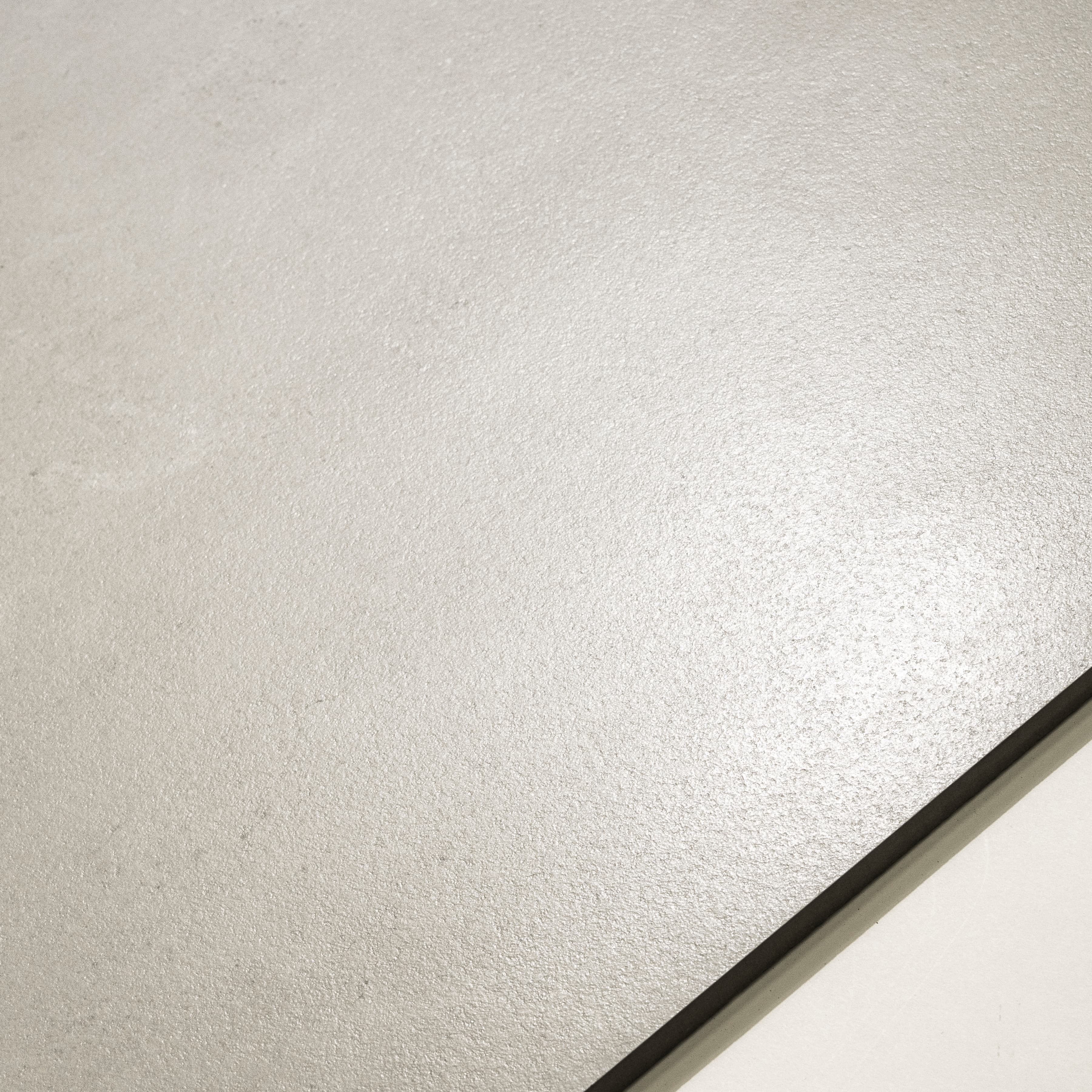 Close-up of Oslo Pearl New matte porcelain surface revealing fine pearlescent texture and subtle hairline grey veins