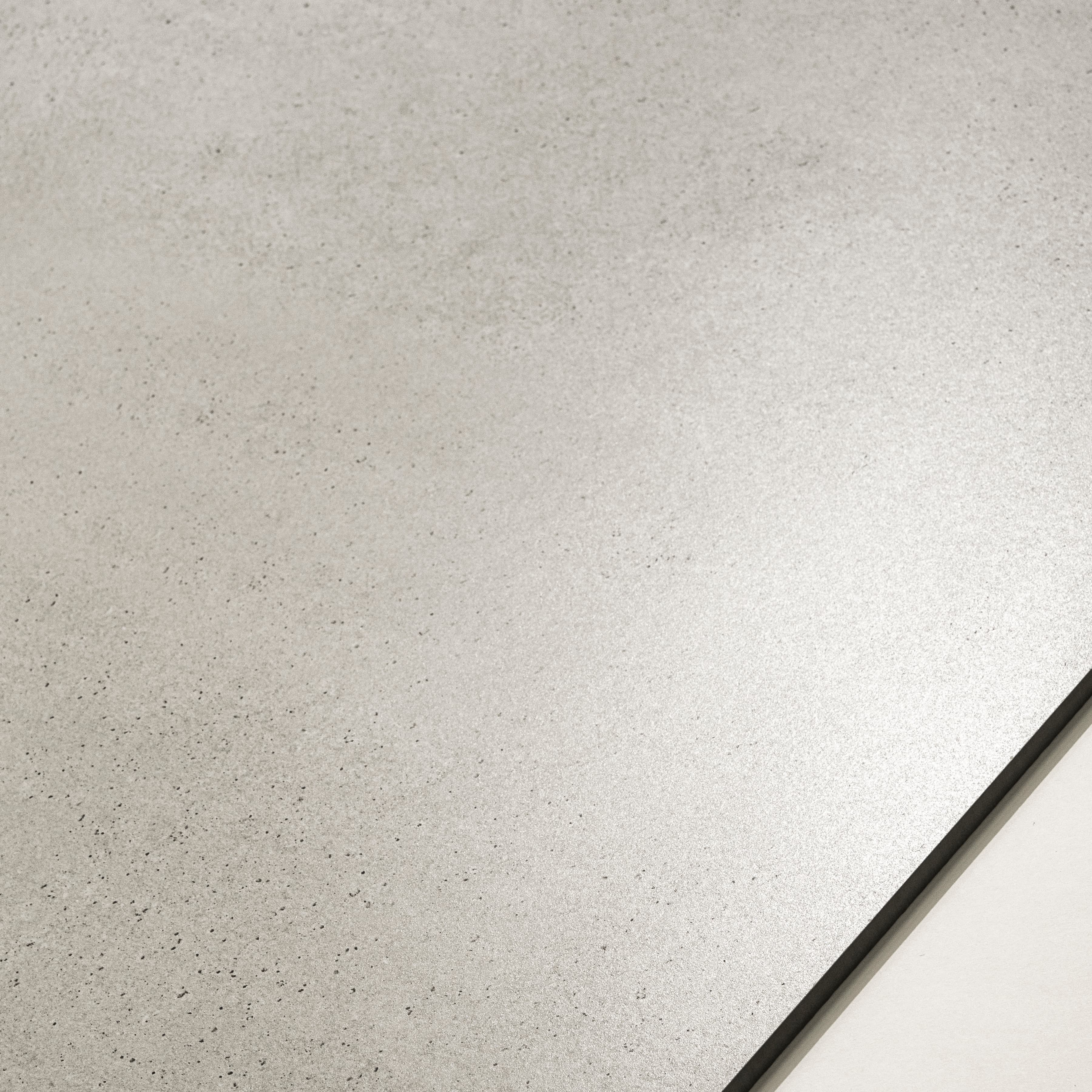 Close-up of Vera Grey matte porcelain surface showing fine dark speckles scattered across light grey base