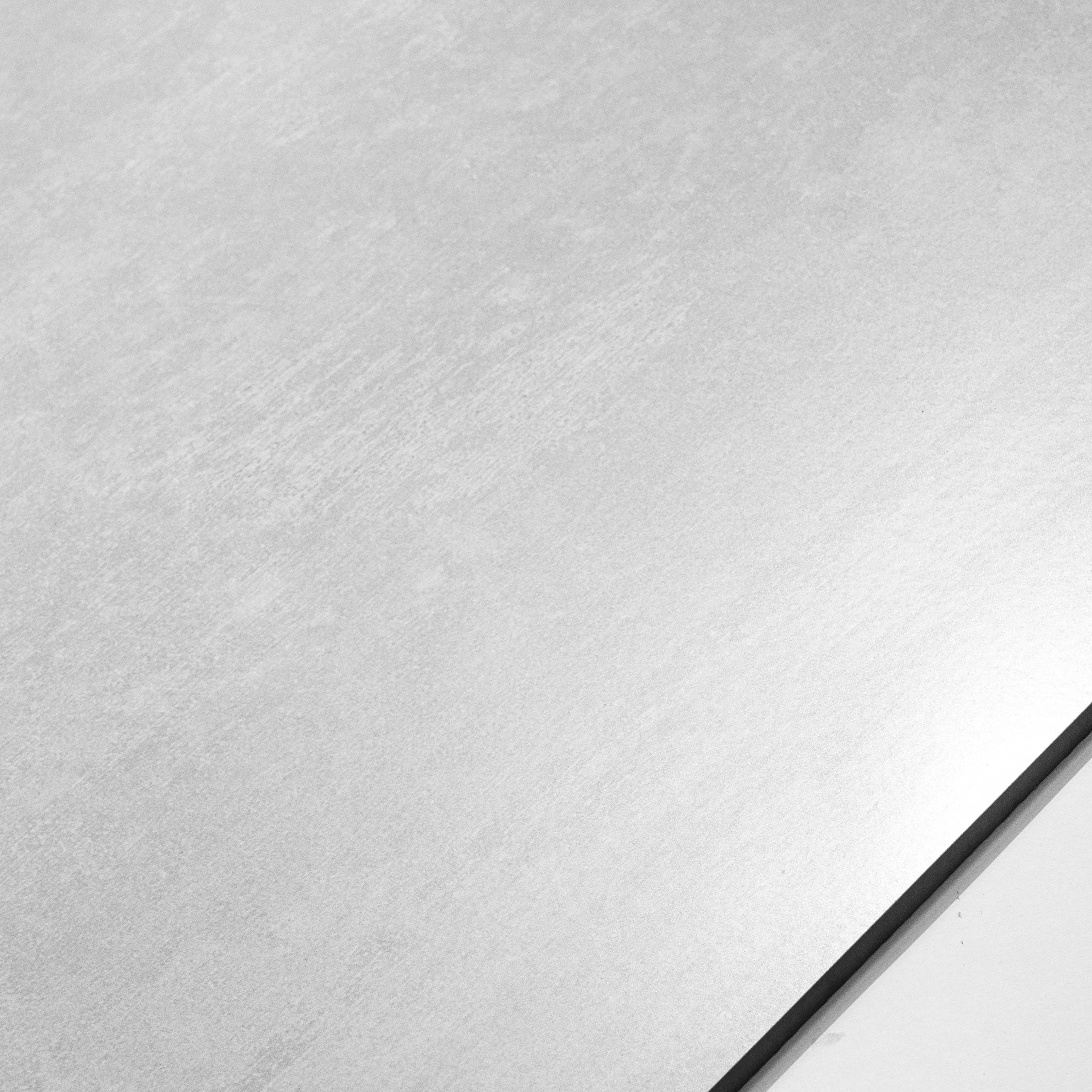 Close-up of Granite White matte porcelain surface revealing soft brushed wash texture in clean designer white tone