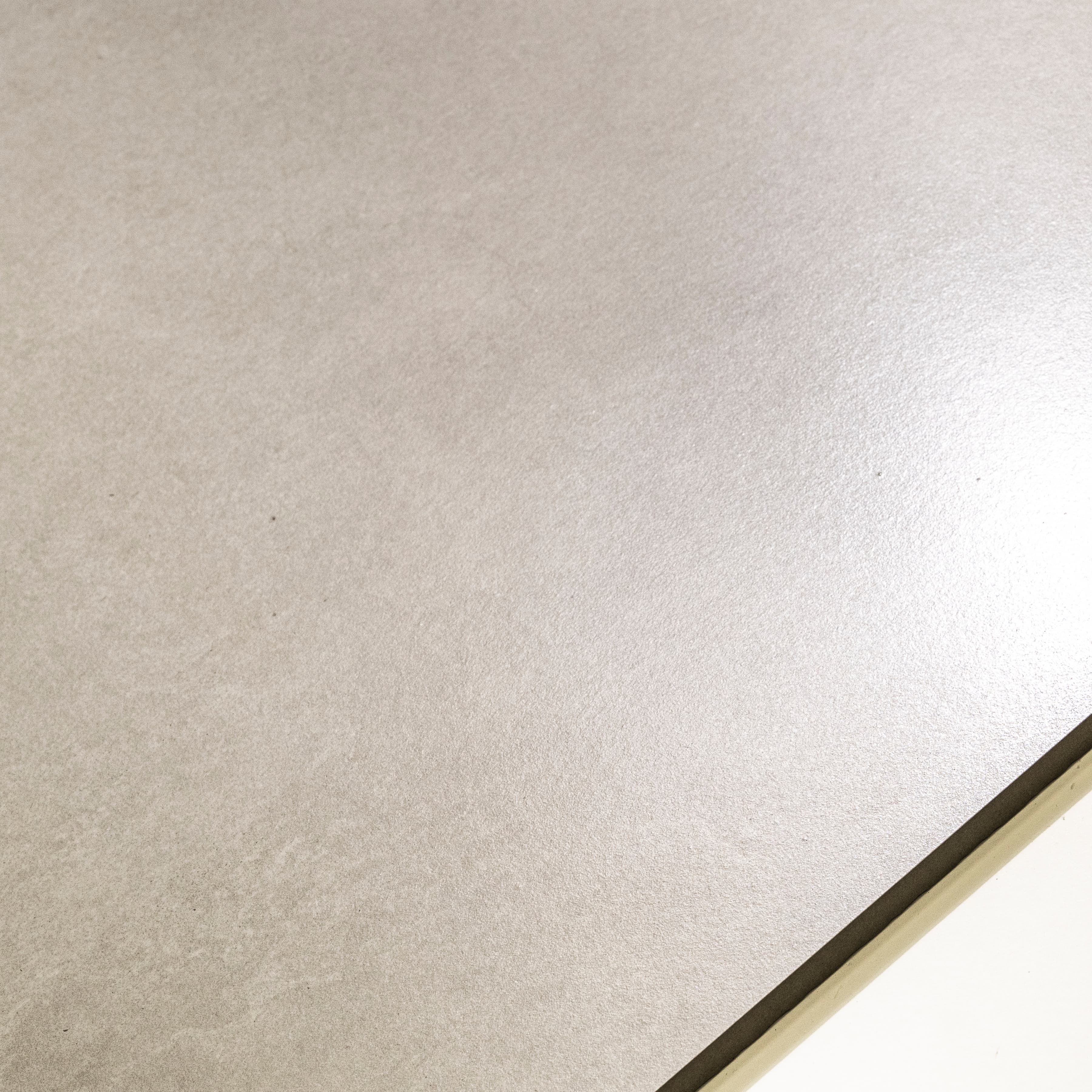 Close-up of Azure Grey matte porcelain surface revealing refined natural texture in warm greige tone