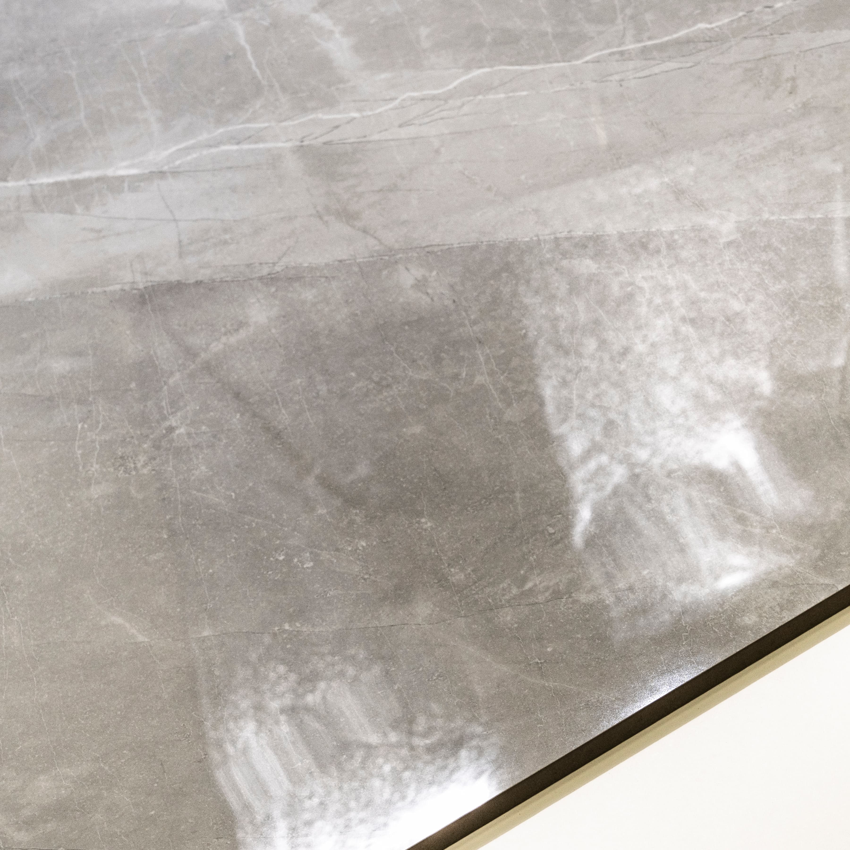 Close-up of Armani Romano high-gloss polished porcelain surface revealing sophisticated dove greige tone and delicate marble veining detail