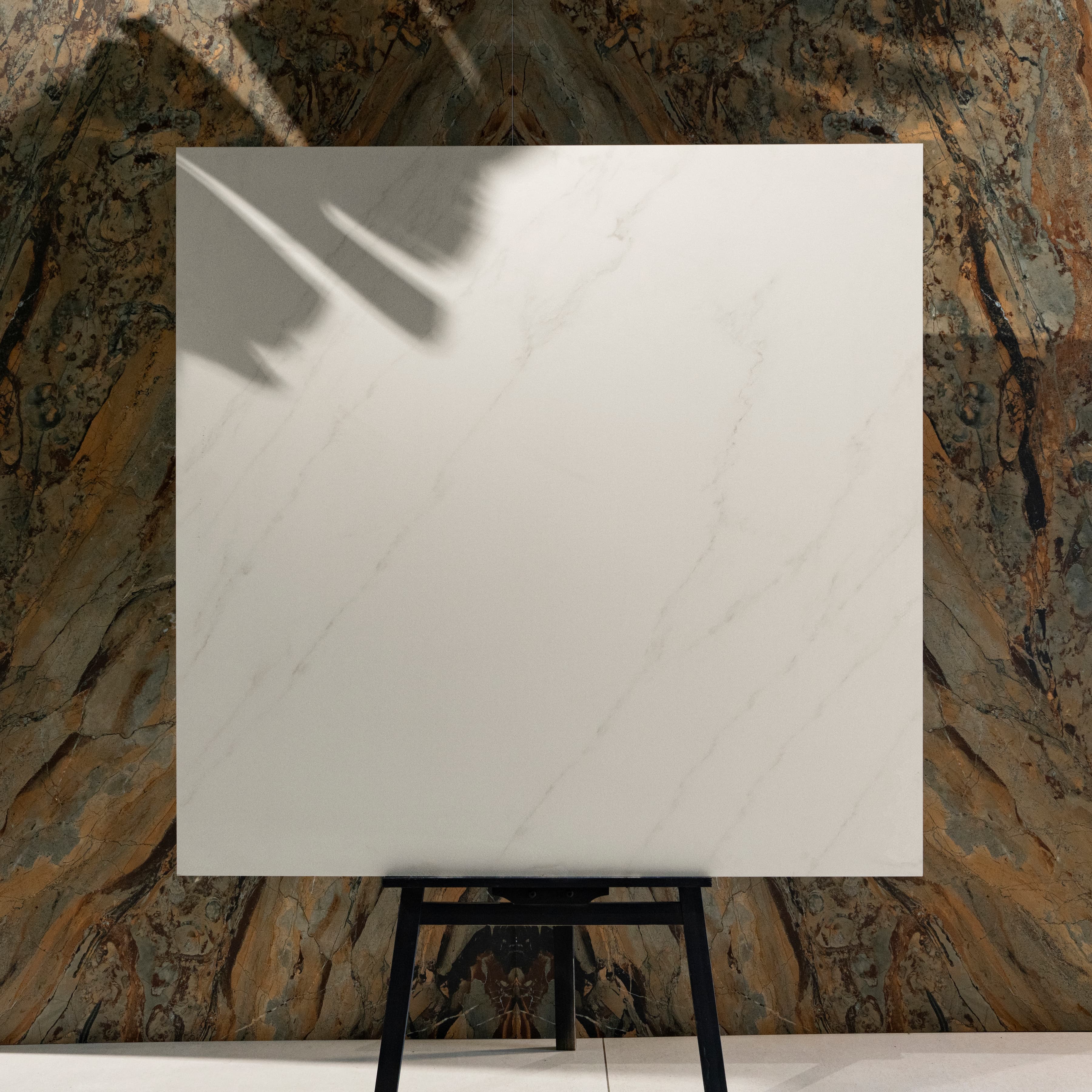Arena Shine 120x120cm pure white minimal marble look matte porcelain tile on easel against onyx backdrop in UAE luxury tile showroom