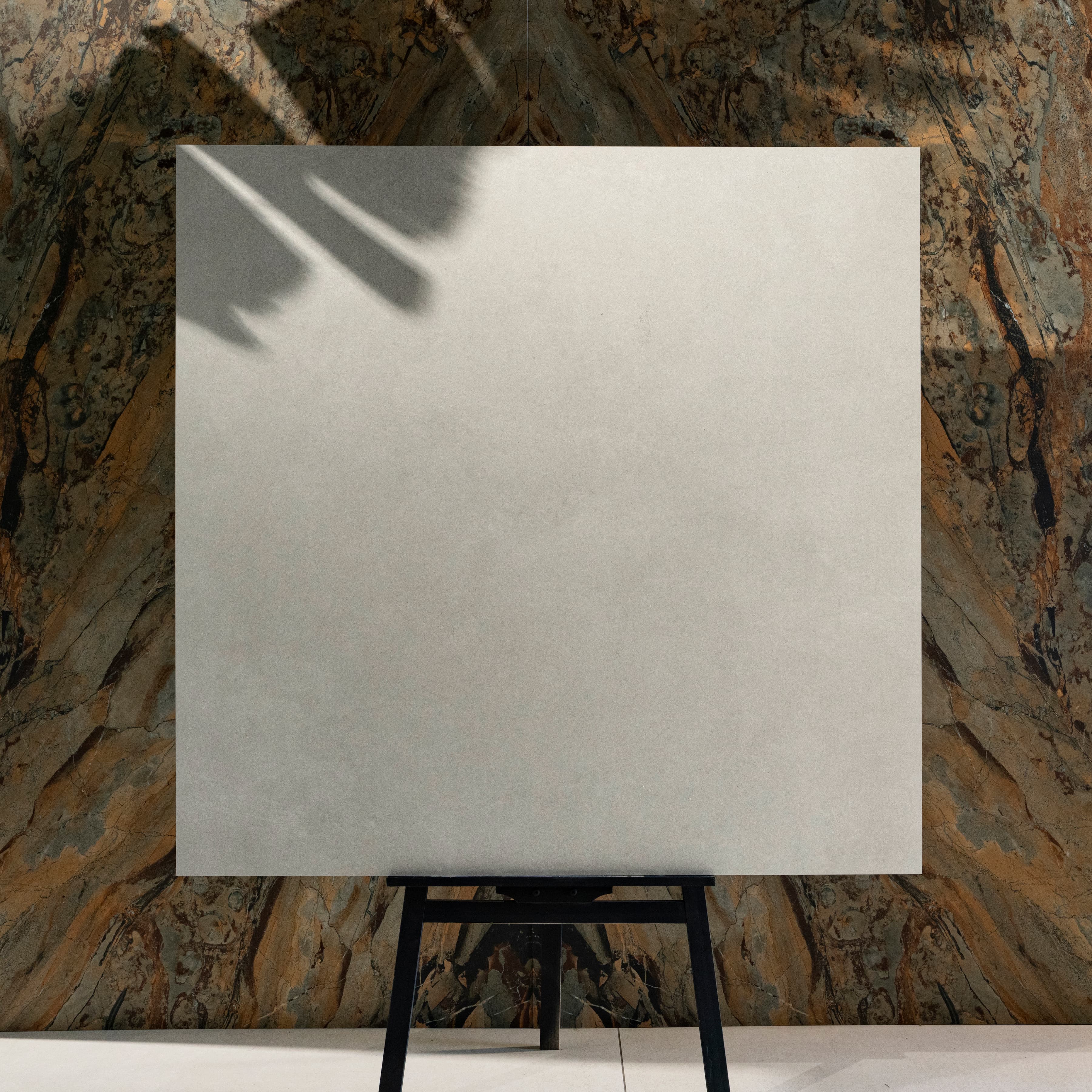 Azure Bianco matte porcelain tile 120x120cm displayed on easel against luxury marble backdrop for UAE interior design