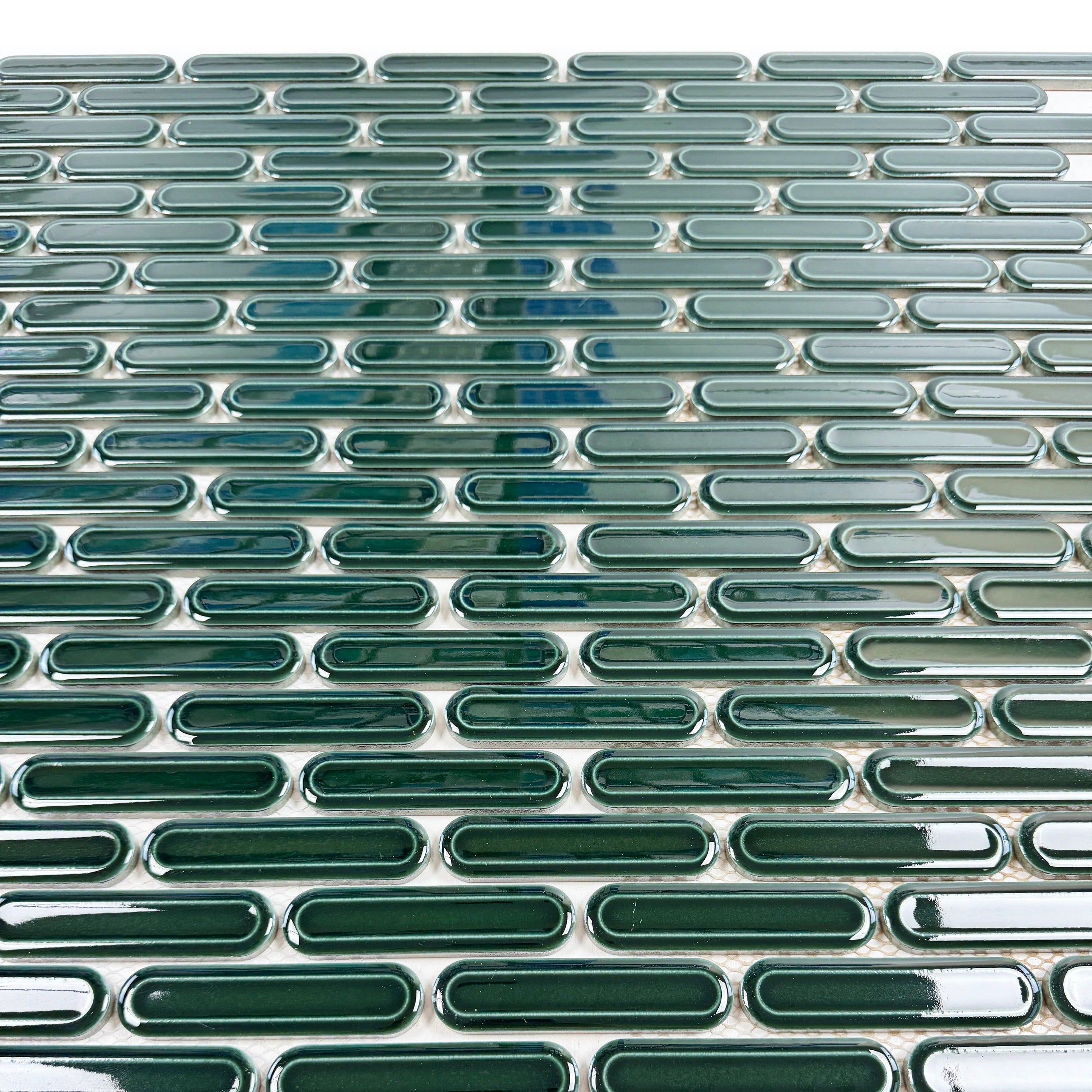 Emerald green elongated oval glossy porcelain mosaic, ideal for walls, backsplashes, and modern interiors with vibrant, sleek, and elegant appeal.