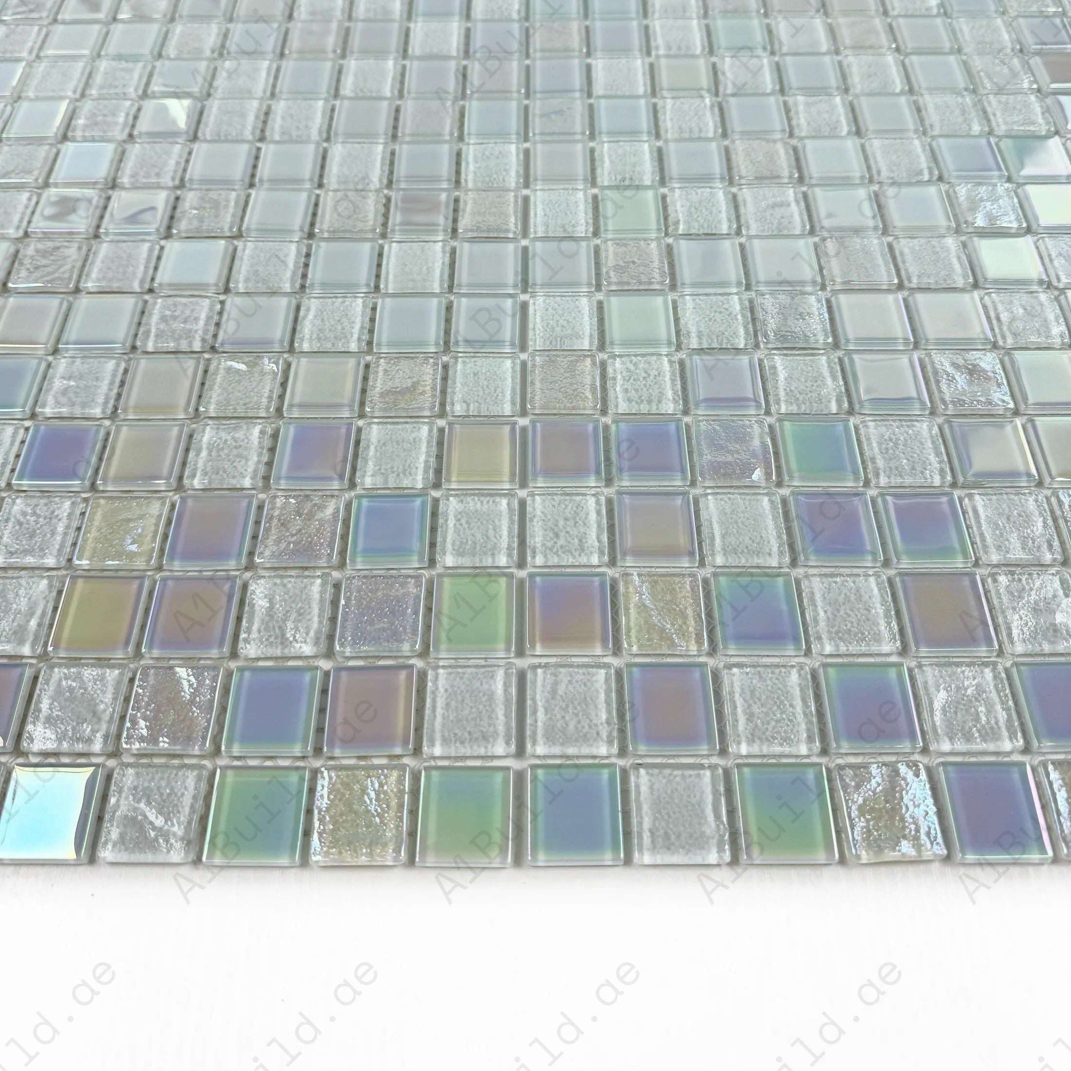 Enhance pools & spas with Crystal Cascade White Iridescent Wave Glass Mosaic. Durable, UV-resistant, non-toxic tiles with shimmering elegance for modern designs.