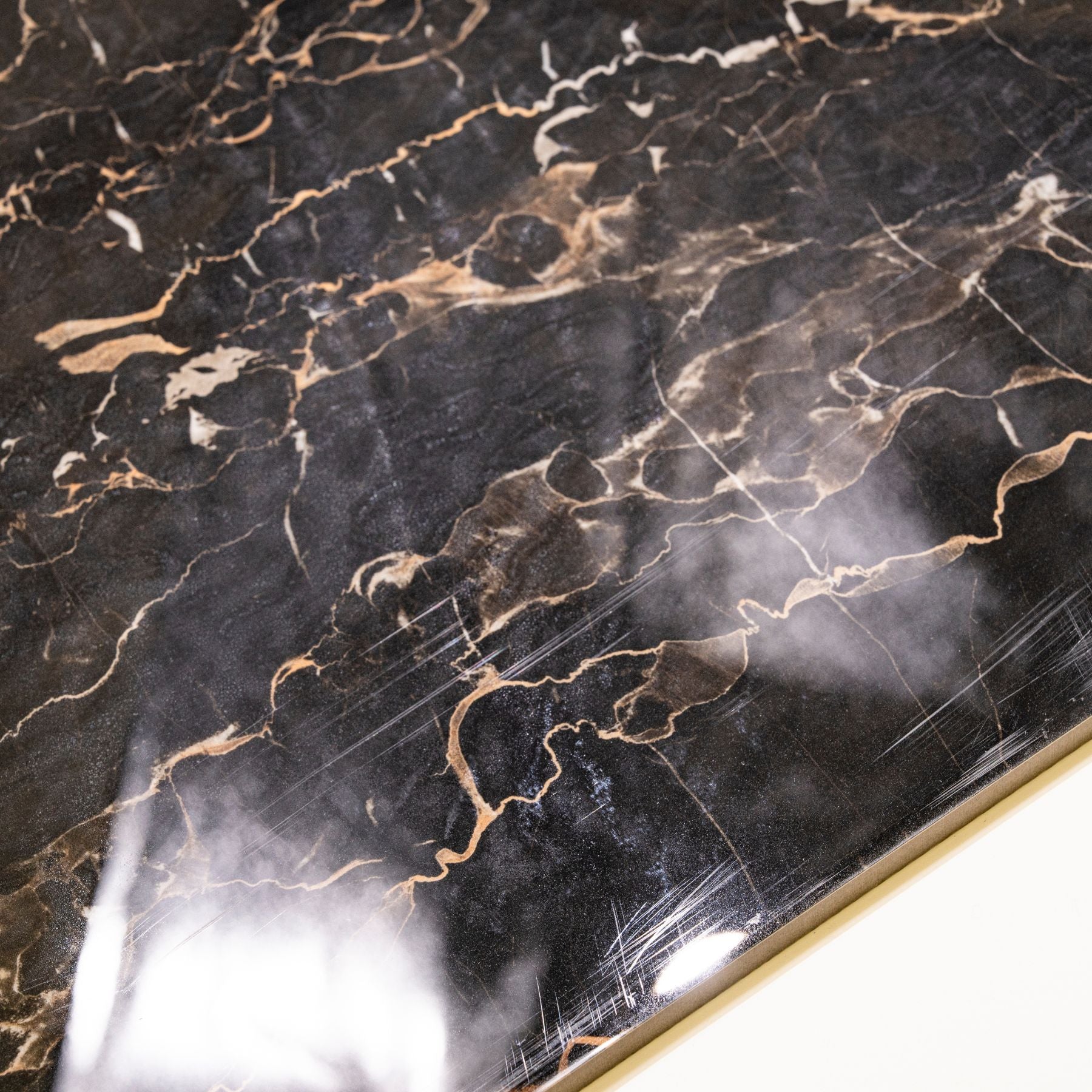 Portoro Gold glossy marble effect porcelain tile 60x120cm with 9mm thickness features black base with rich gold veining and polished finish.